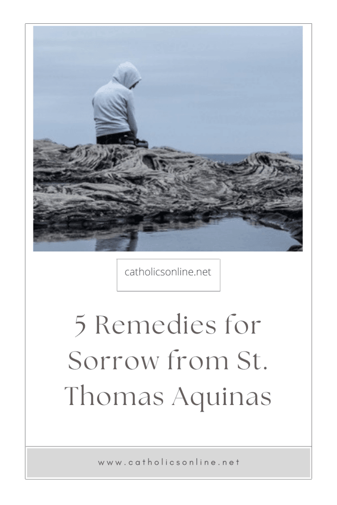 man in sweatshirt sitting on a rock by the sea, looking sad. Text: 5 Remedies for Sorrow from St. Thomas Aquinas